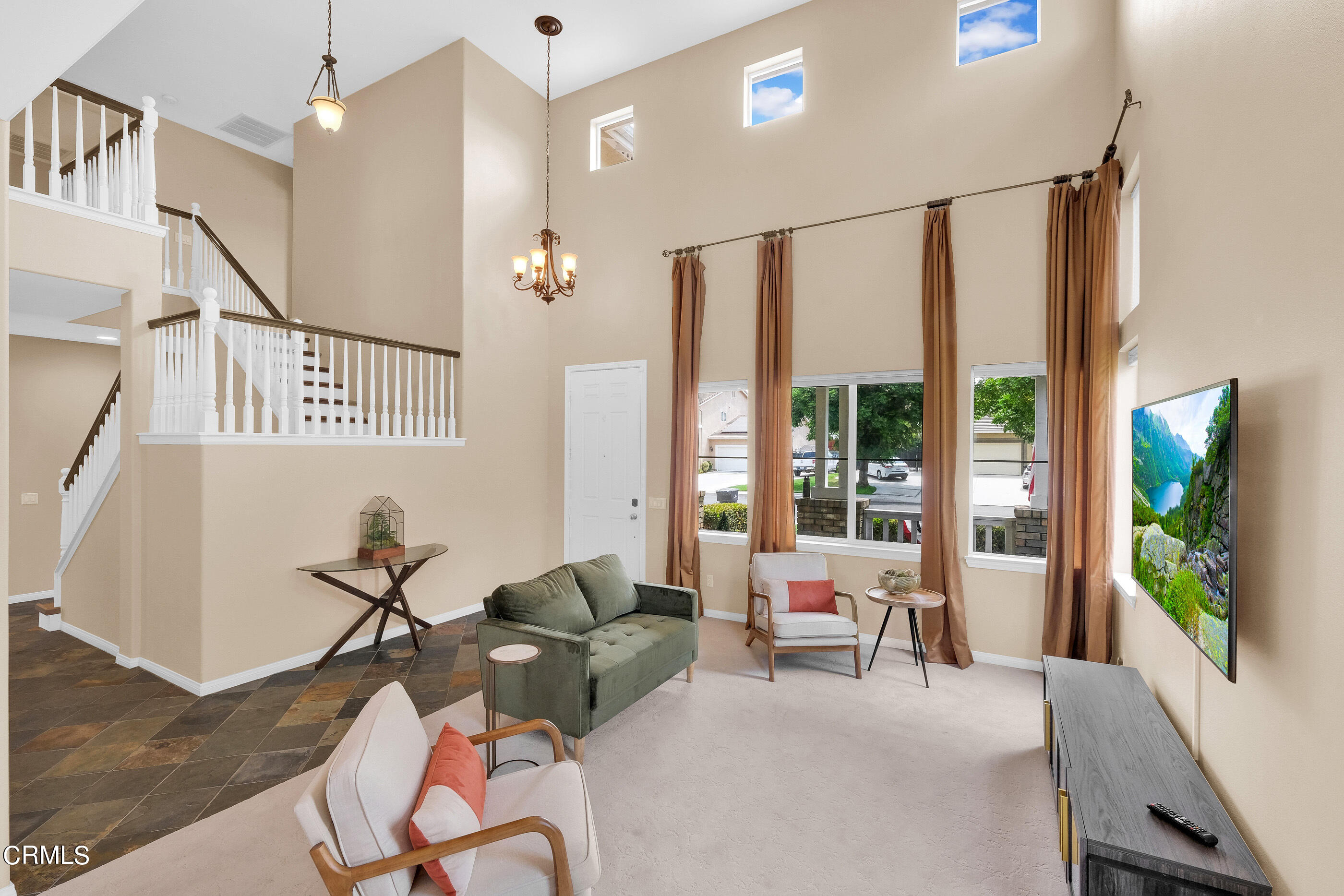 8317 Carriage Court Riverside, CA 92508 - Photo 6 of 37 a living room with furniture a flat screen tv and a large window