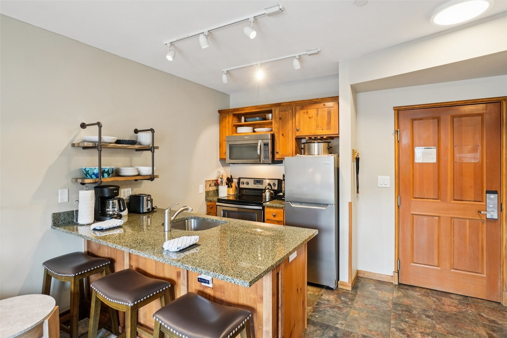 129 River Run Road, Unit 8055 Keystone, CO 80435 - Photo 11 of 50 Kitchen with appliances with stainless steel finishes, open shelves, a sink, and a peninsula