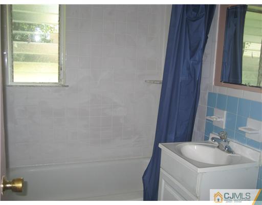 34 Idlewild Road Edison, NJ 08817 - Photo 6 of 7 a bathroom with a sink and a window