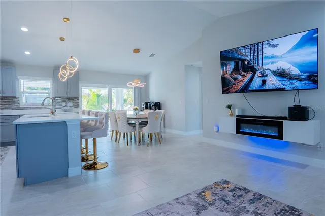 a view of a kitchen with dining table and chairs