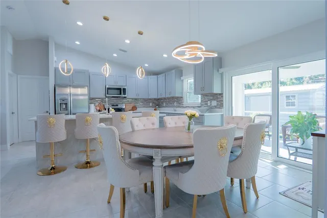 a dining room with furniture a window and a kitchen view