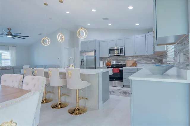 a kitchen with kitchen island cabinets and refrigerator