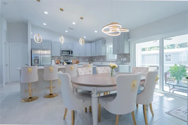 a dining room with furniture a window and kitchen view