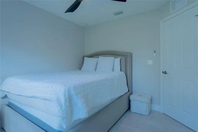 a bed room with a bed and a night stand