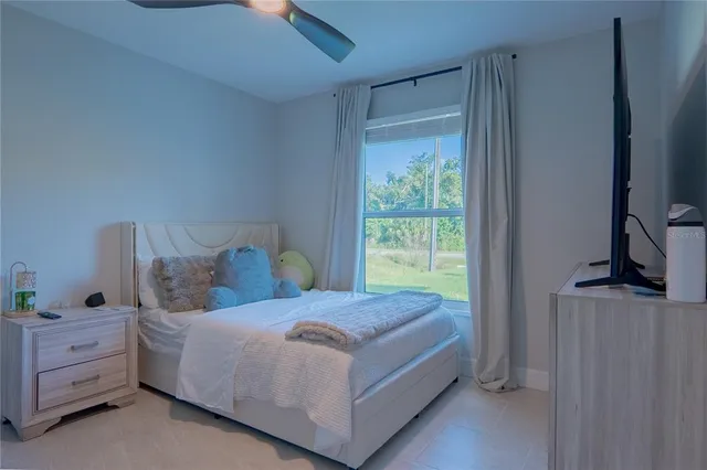 a bed sitting in a bedroom next to a window