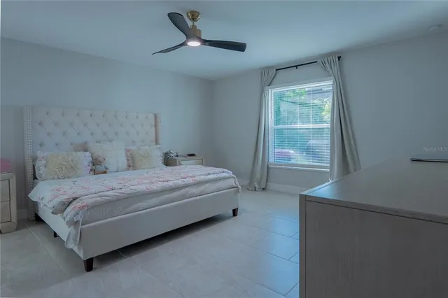 a bedroom with a bed and a window