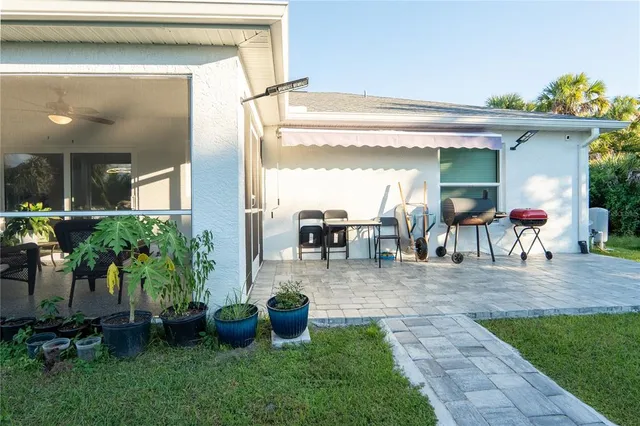 a view of a porch with chairs and potted plants