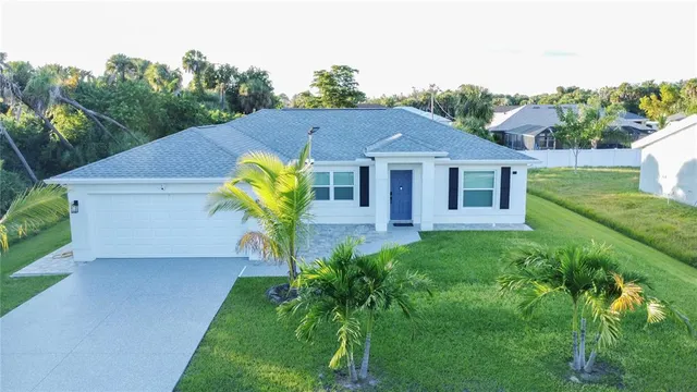 a view of a house with pool and a yard