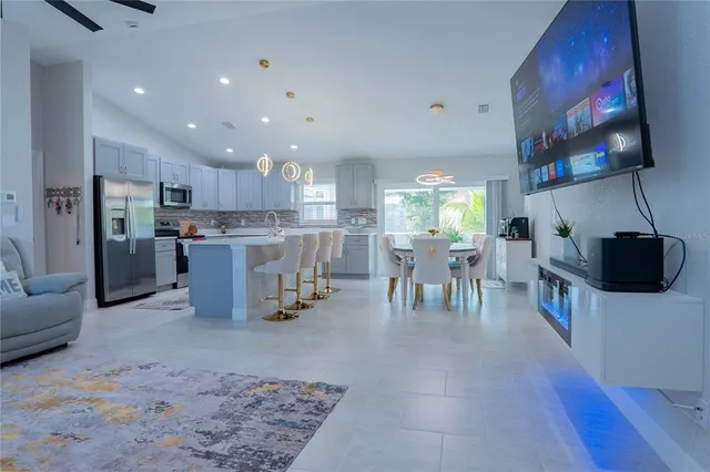 a view of a kitchen with dining table and chairs