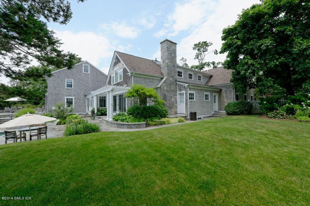160 Shore Road Old Greenwich, CT 06870 - Photo 14 of 15 a front view of house with yard and green space