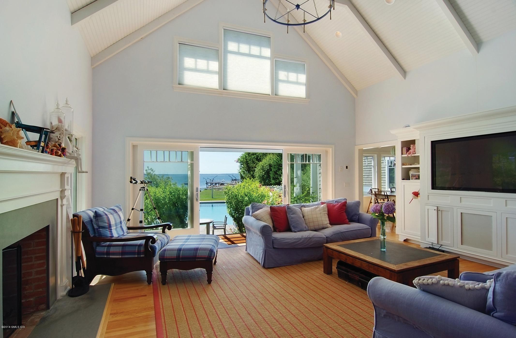 160 Shore Road Old Greenwich, CT 06870 - Photo 2 of 15 a living room with furniture flat screen tv and a fireplace