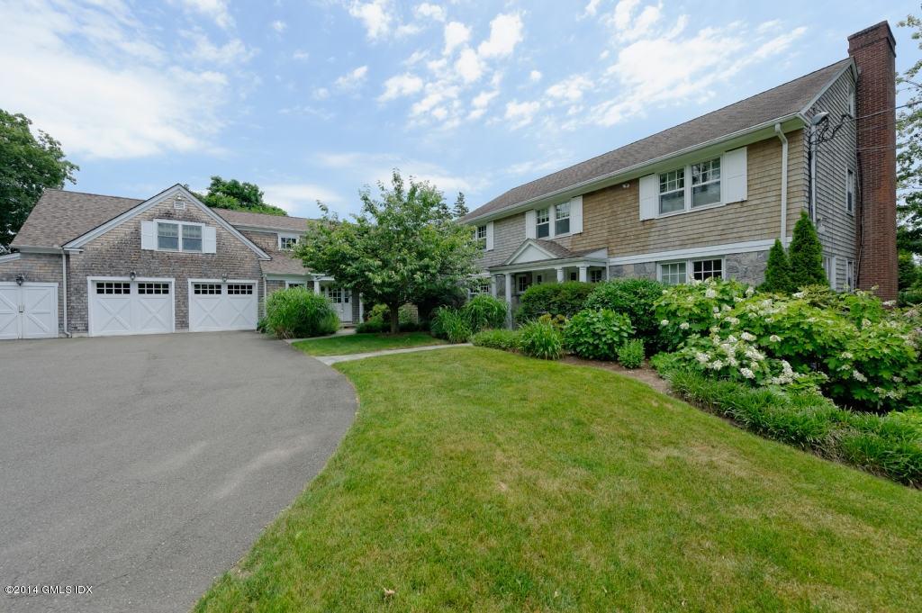 160 Shore Road Old Greenwich, CT 06870 - Photo 9 of 15 a front view of a house with a yard and garage