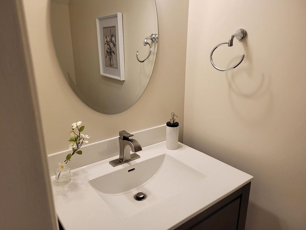 1401 Camp Craft Road, Unit C Austin, TX 78746 - Photo 10 of 12 A well-appointed bathroom vanity with a crisp white sink and contemporary fixtures.