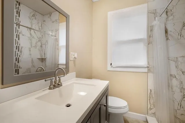 a bathroom with a sink toilet and shower