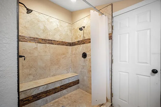 a bathroom with a glass shower door