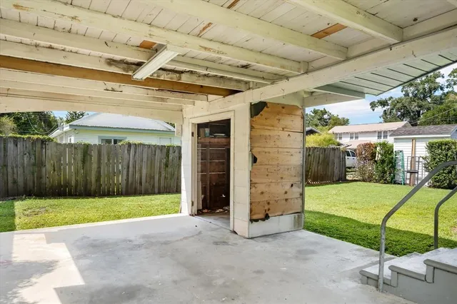 a view of a backyard with table and chairs