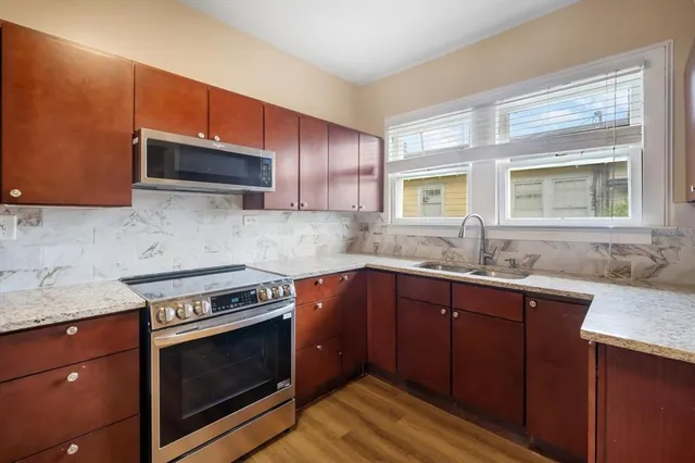 a kitchen with a sink stove and microwave