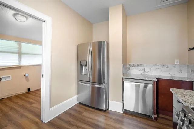 a view of a kitchen counter space and wooden floor