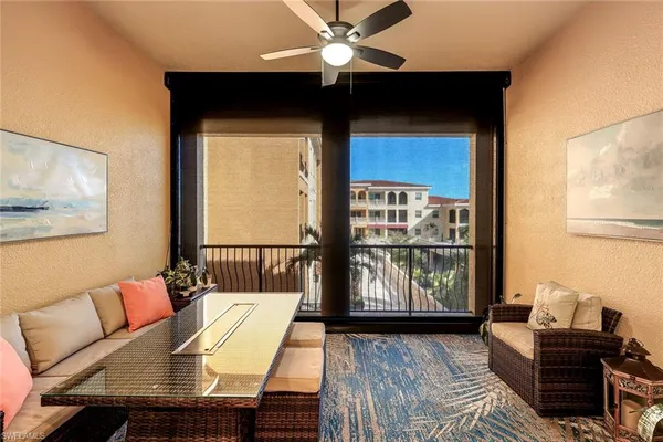 a living room with furniture and a floor to ceiling window