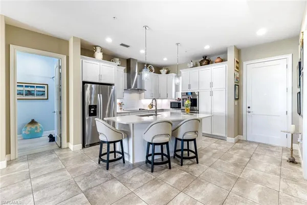 a living room with furniture and a painting on the wall