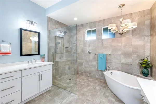 a bedroom with bed and a chandelier