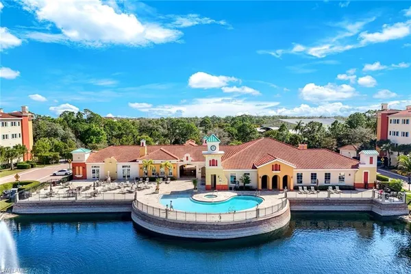 a view of a lake with couches chair and a table