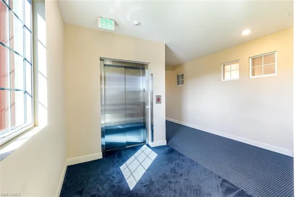 an empty room with windows and closet