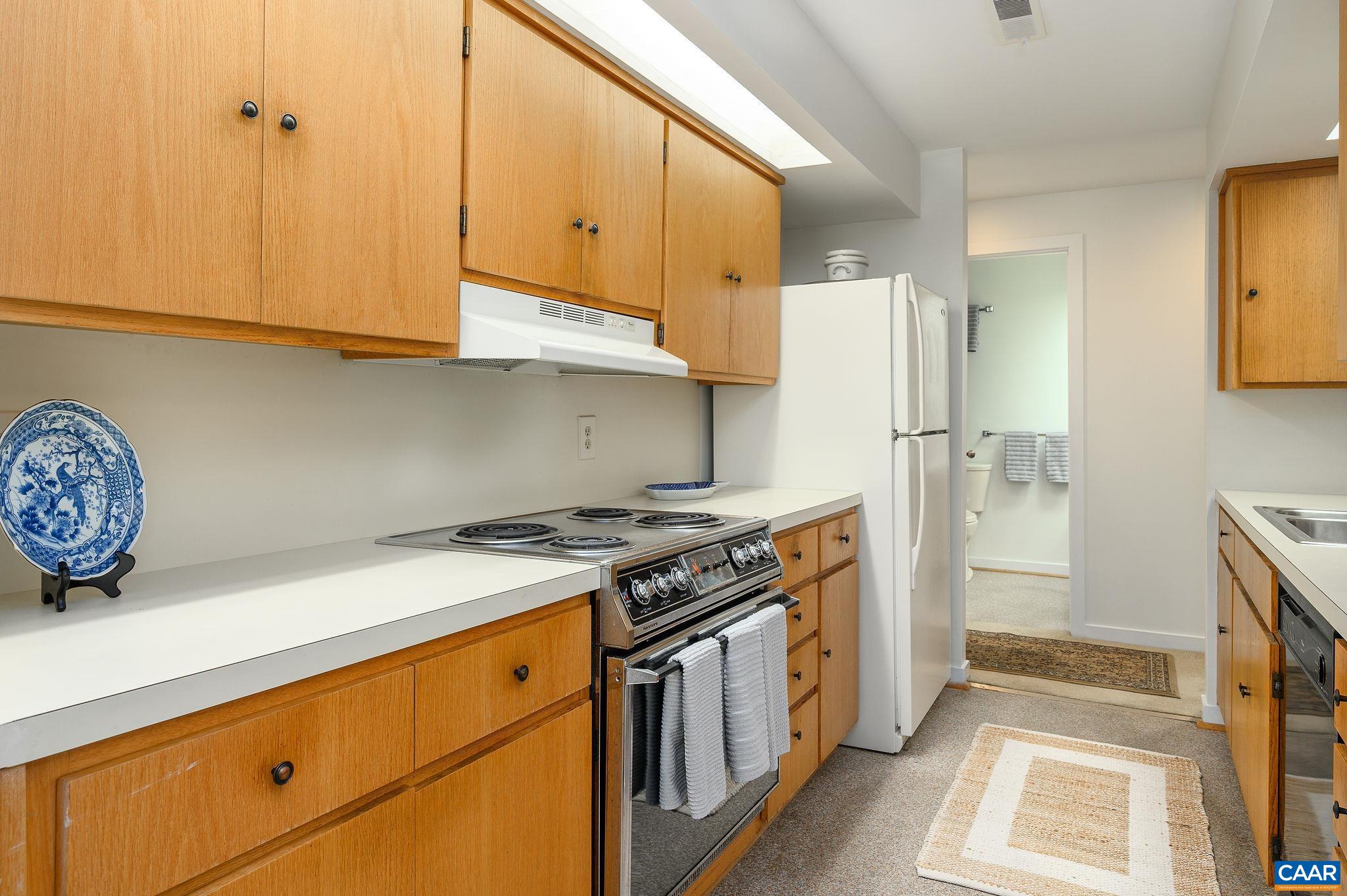 207 2nd Street Northwest, Unit D Charlottesville, VA 22902 - Photo 13 of 18 a kitchen with stainless steel appliances granite countertop a stove a refrigerator and a cabinets