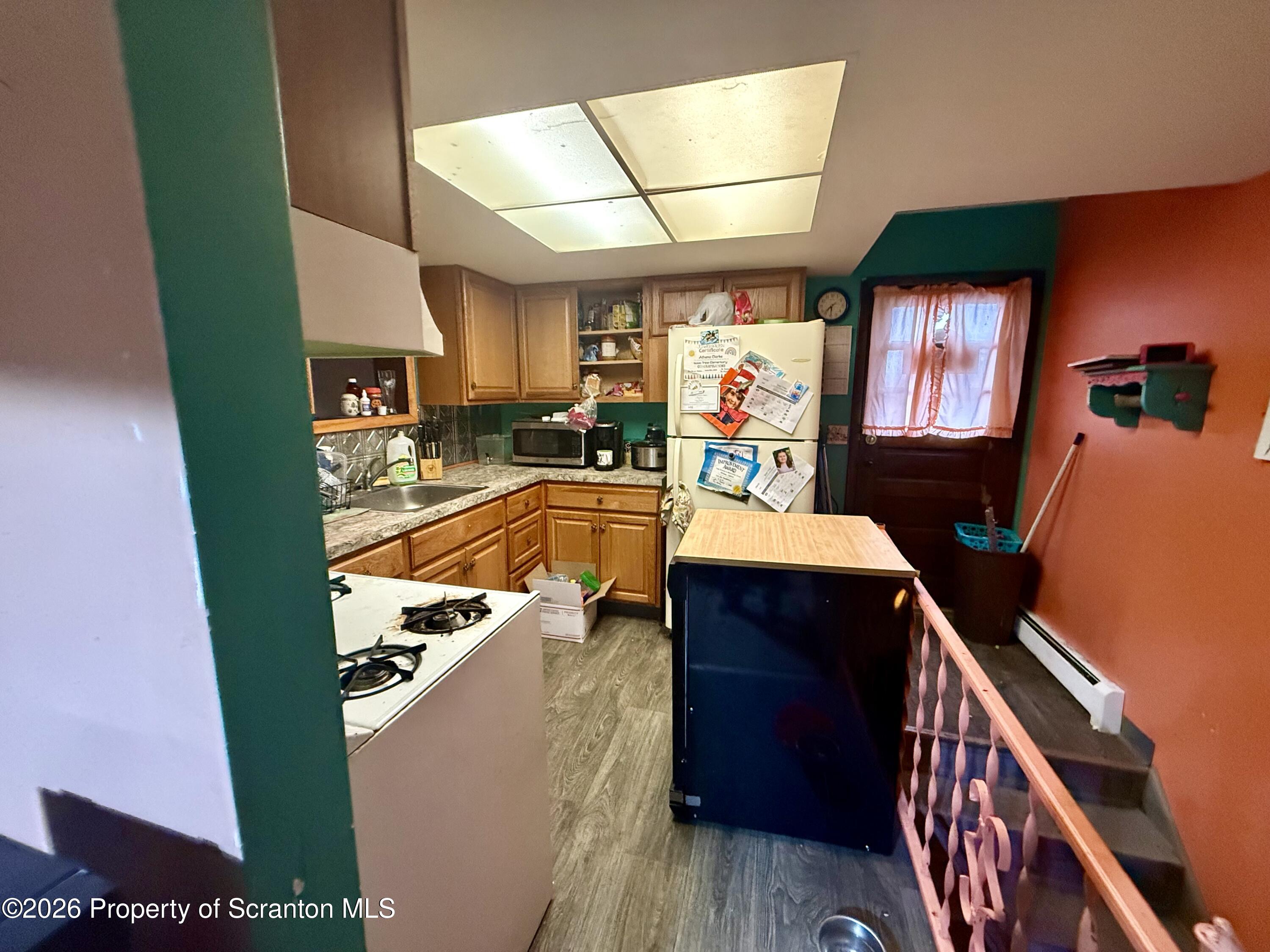 2712 Lafayette Street Scranton, PA 18504 - Photo 14 of 18 a view of living room kitchen with furniture and a fireplace