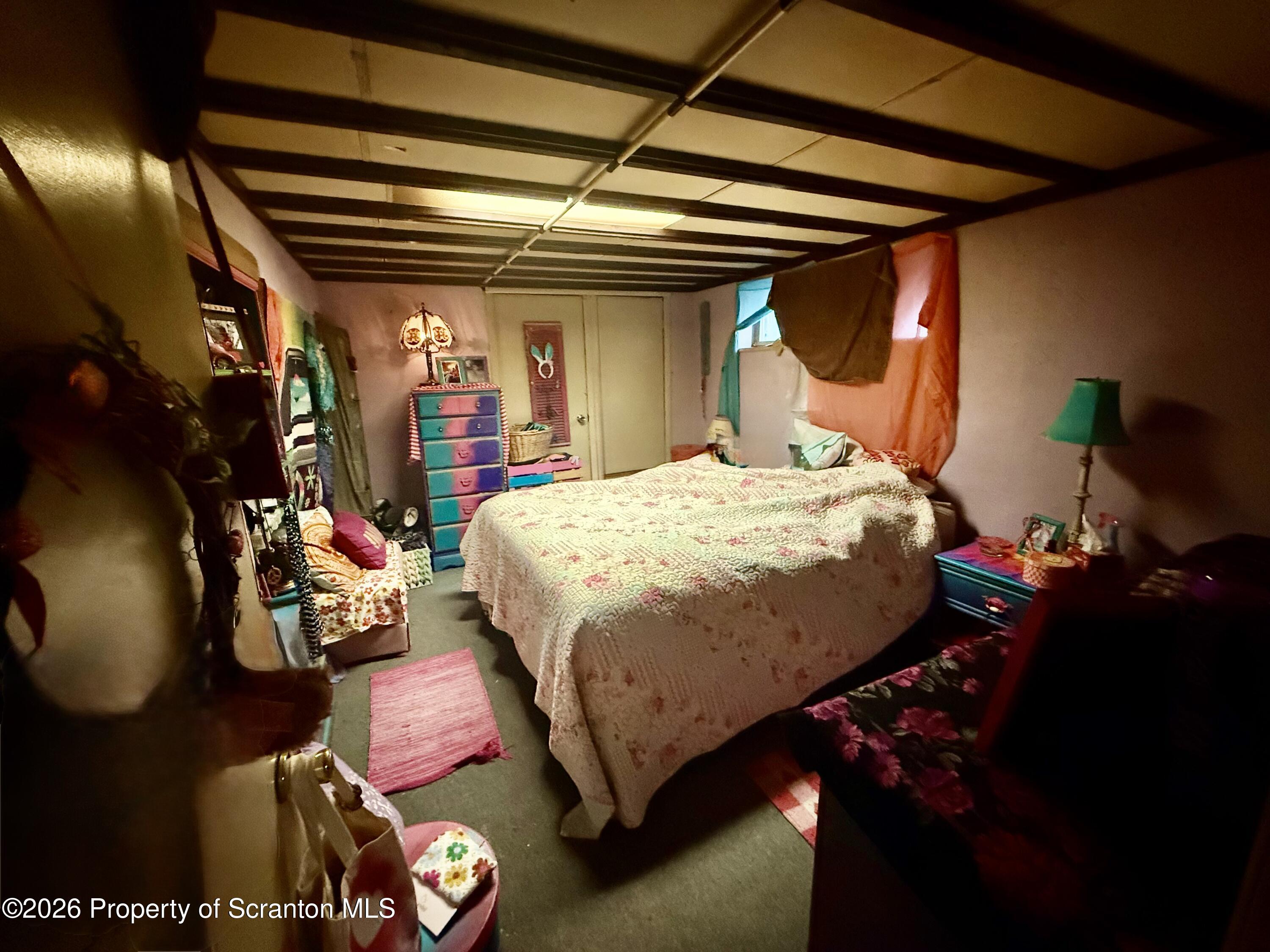 2712 Lafayette Street Scranton, PA 18504 - Photo 2 of 18 a bed room with a bed and a chandelier