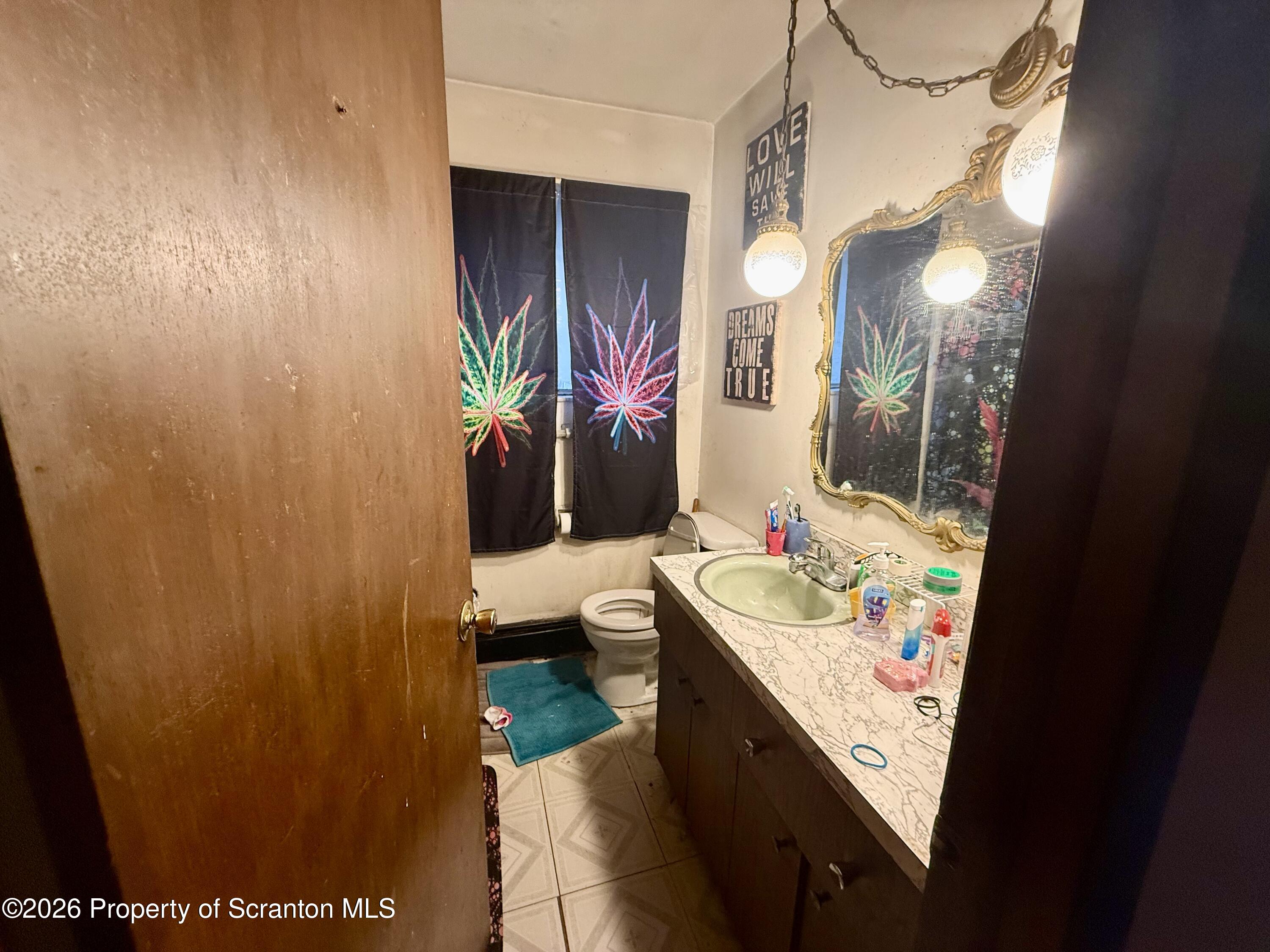 2712 Lafayette Street Scranton, PA 18504 - Photo 8 of 18 a bathroom with a sink vanity and toilet