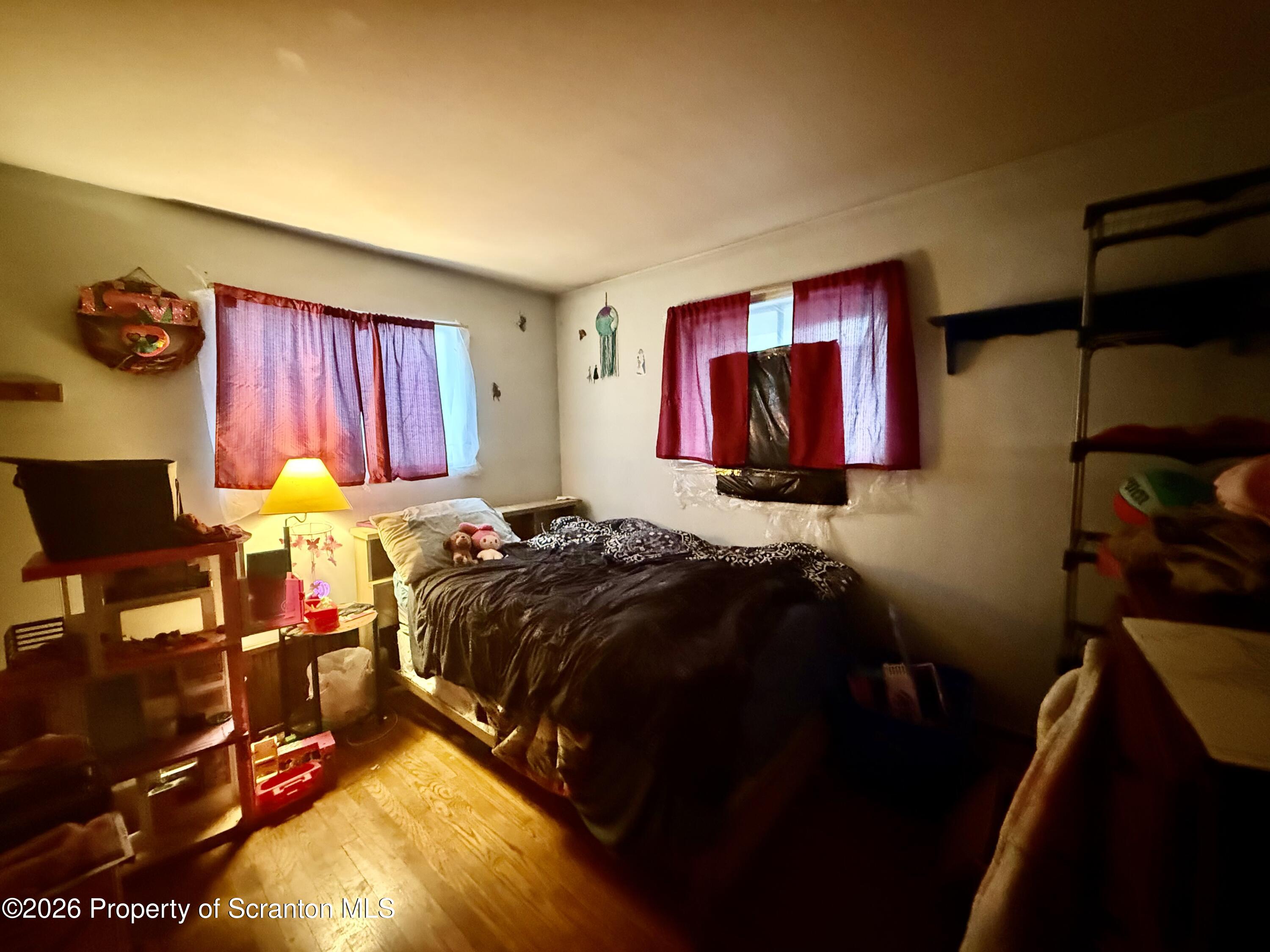2712 Lafayette Street Scranton, PA 18504 - Photo 9 of 18 a bed sitting in a bedroom next to a window