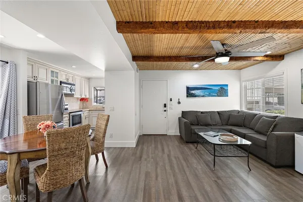a living room with furniture a flat screen tv and a window