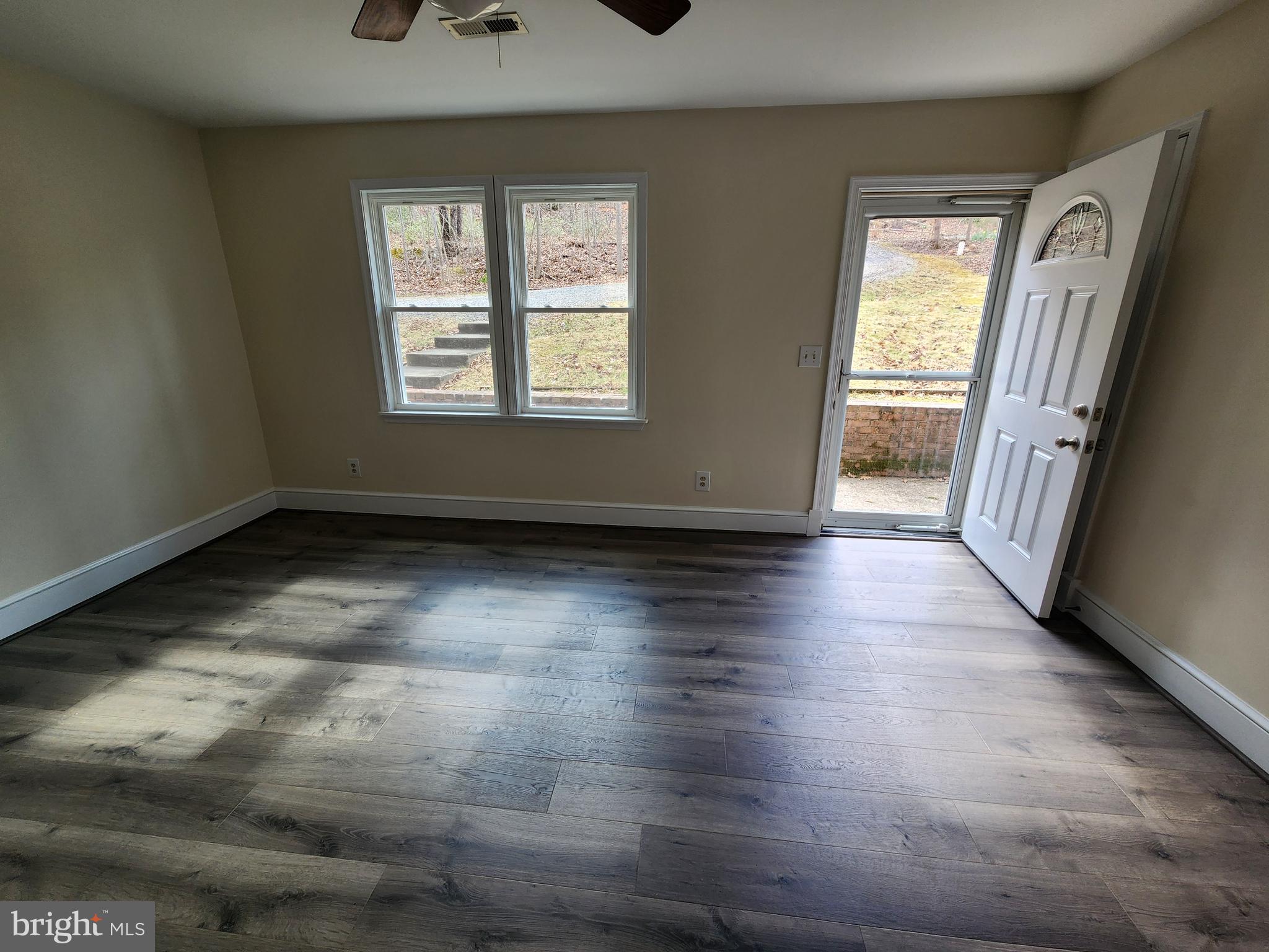 156 Dry Run Court Front Royal, VA 22630 - Photo 2 of 34 an empty room with wooden floor and windows