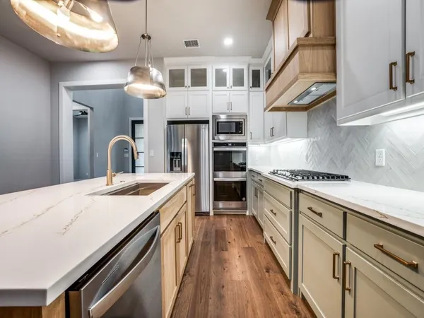 a kitchen with stainless steel appliances granite countertop a sink and cabinets