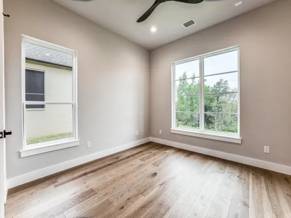 a view of an empty room with a fireplace and a window