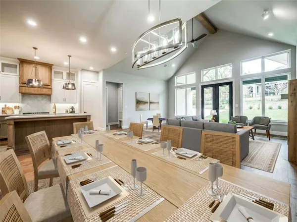 a living room with lots of furniture and view of kitchen