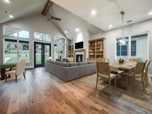 a living room with furniture and a wooden floor