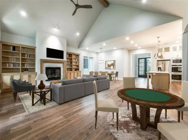 a living room with furniture a fireplace and a flat screen tv