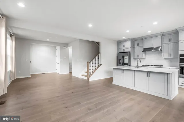 a view of kitchen with wooden floor and electronic appliances
