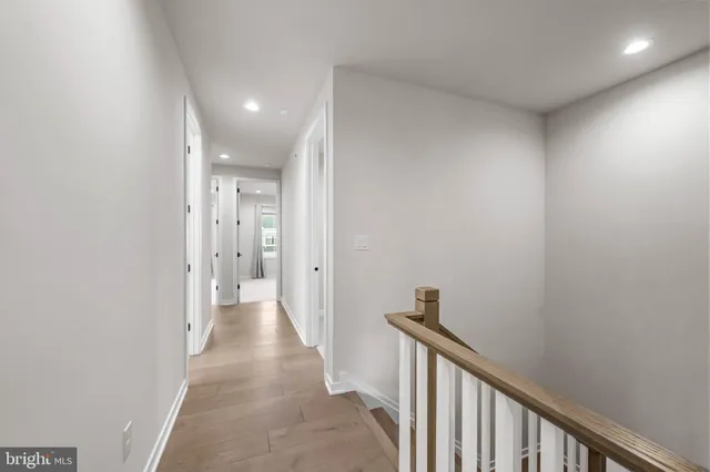 a view of a hallway with wooden floor