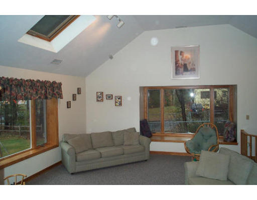 43 Breakneck Road Sturbridge, MA 01566 - Photo 2 of 6 a living room with furniture and a floor to ceiling window