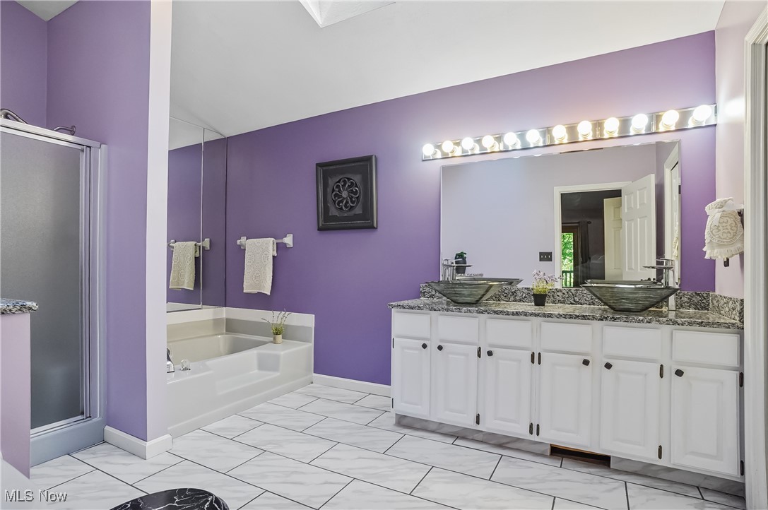 370 Wilcox Road Youngstown, OH 44515 - Photo 31 of 49 Bathroom featuring a stall shower, double vanity, a bath, and lofted ceiling