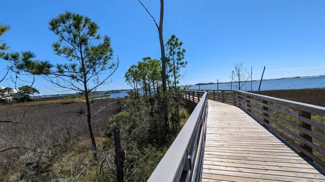 a view of balcony with wooden floor and fence