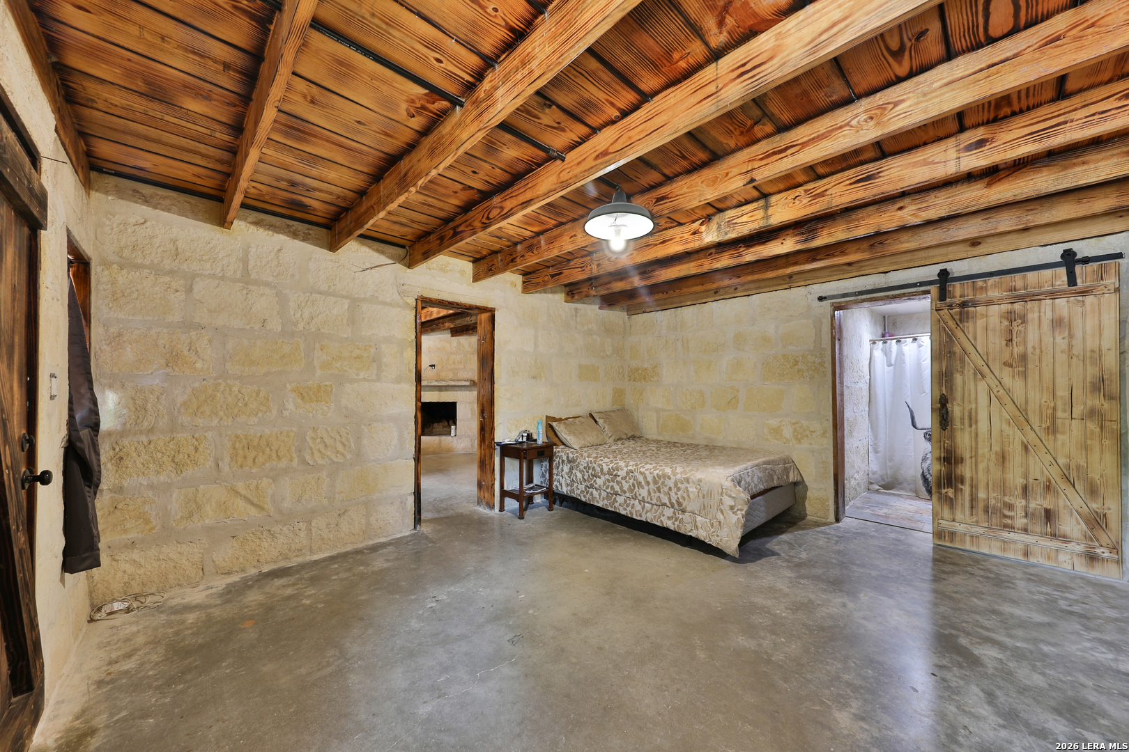 122 Brink Center Point, TX 78010 - Photo 13 of 40 a spacious bedroom with a bed and a table