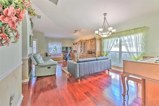 a living room with furniture and a chandelier