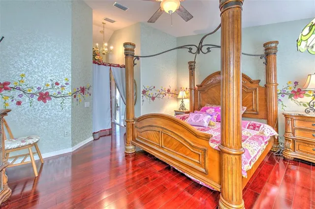 a bedroom with a bed and a chandelier