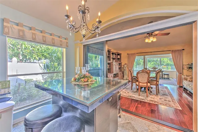 a kitchen with stainless steel appliances granite countertop a refrigerator a sink dishwasher a stove and wooden cabinets