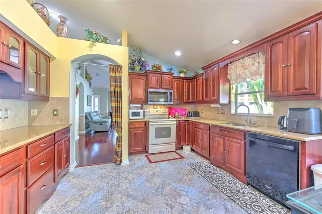 a dining room with furniture a chandelier and window