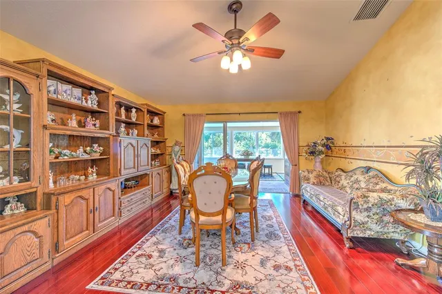 a dining room with furniture lamps and wooden floor